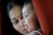 © Saptak Ganguly/Stocksy - Cute baby girl with her mother smiling