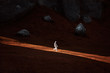© HOWL/Stocksy - A lone astronaut descends the side of a mountain