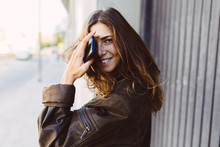 Woman Outdoors, Holding A Cell Phone