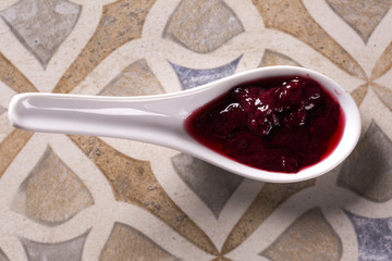 Wall Mural - Red fruit cream on the spoon