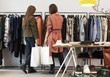 © W2 Photography/Stocksy - Two friends clothes shopping in a boutique