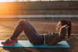 © Studio Firma/Stocksy - Woman doing exercise outside