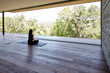 © Trinette Reed/Stocksy - Woman meditating on yoga deck