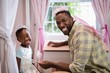 © WavebreakMediaMicro - Happy father and daughter wearing costume wings at home