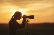 © Raymond Forbes LLC/Stocksy - Woman With Binoculars on Marsh