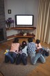© wavebreak3 - Family watching television together in living room