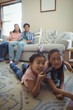 © wavebreak3 - Family watching television together in living room