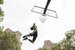 © Simone Becchetti/Stocksy - Young man playing basketball outdoors