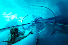 Little Girl Speeding Down Giant Water Slide Tube