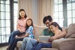 © WavebreakMediaMicro - Smiling family using digital tablet together in living room