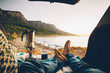 © Micky Wiswedel/Stocksy - point of view a person camping in the back of his car and making a pot of coffee