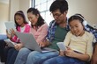 © WavebreakMediaMicro - Family using laptop, digital tablet and mobile phone in living room at home