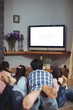© WavebreakMediaMicro - Family watching television together in living room