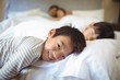 © wavebreak3 - Siblings sleeping on bed in bedroom