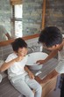 © wavebreak3 - Son brushing his teeth with father in bathroom