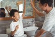 © wavebreak3 - Father and son giving high five to each other in bathroom