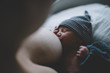 © Cameron Whitman/Stocksy - Newborn baby breastfeeding in the hospital