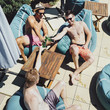 © Lumina/Stocksy - Men Enjoying Beer by the Pool