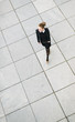 © Simone Becchetti/Stocksy - Businesswoman walking - overhead