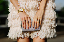 Close Up Of A Girl In A Dress Holding Clutch Bag