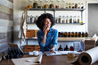 © Trinette Reed/Stocksy - Millennial African American Woman businesswoman on the phone in her skincare studio