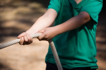 Wall Mural - boy practicing tug of war during obstacle course