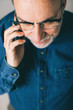 © BONNINSTUDIO/Stocksy - Mature man talking on mobile phone