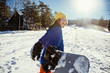 © Boris Jovanovic/Stocksy - Young snowboarder holding his snowboard