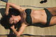 © Alexey Kuzma/Stocksy - young woman is tanning