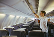 © Jovo Jovanovic/Stocksy - Man taking his luggage from plane's overhead compartment