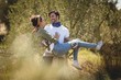 © WavebreakMediaMicro - Young man carrying girlfriend by trees at farm