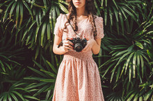 Beautiful Girl With Curly Hair Holds An Analog Camera