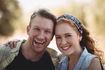 Wall Mural - Portrait of cheerful young couple at olive farm