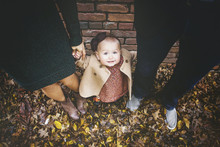 Cute, Dressed Up Little Girl Looking Up At Camera In Fall