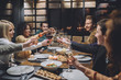 © Lumina/Stocksy - Group of Friends Making a Toast at a Dinner Party
