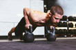 © BONNINSTUDIO/Stocksy - Man working out with kettle bells in a gym