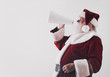 © Sean Locke/Stocksy - Santa Claus Yelling Through Megaphone