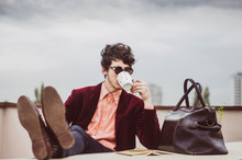 Young Business Man Relaxing With Cup Of Coffee On Teracce 
