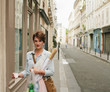 © Jesse Morrow/Stocksy - Young Woman walks through Paris
