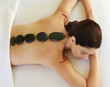 © Trinette Reed/Stocksy - Woman receiving hot stone massage at luxury spa