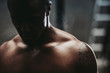 © Rob and Julia Campbell/Stocksy - Young, fit black man recovering after training hard in fitness gym