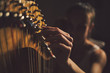 © Lumina/Stocksy - Woman Playing the Harp