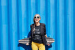 © Trinette Reed/Stocksy - Hip and stylish senior woman with skateboard
