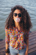 © Jovo Jovanovic/Stocksy - Girl with curly hair blowing a bubble with pink bubblegum