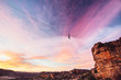 © Micky Wiswedel/Stocksy - Man balance walking a highline or tight rope high over a rocky valley at sunset