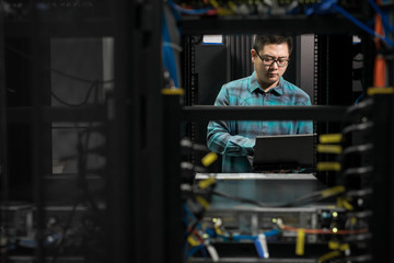 Young engineer working in datacenter