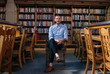 © Jesse Morrow/Stocksy - Portrait of young man in library on college campus