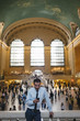 © Simone Becchetti/Stocksy - Businessman using a phone in Grand Central Station - New York