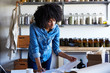 © Trinette Reed/Stocksy - Millennial African American Woman businesswoman in her skincare studio