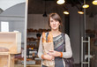 © Mosuno/Stocksy - Woman Walking Out of the Bakery